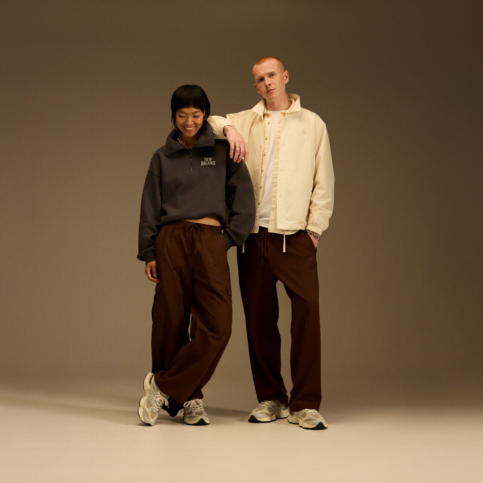 On-figure / head to toe shot of the 9060s being modeled by a man and a woman.